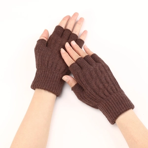 Close-up of brown cable knit fingerless gloves showing warm textured fabric detail