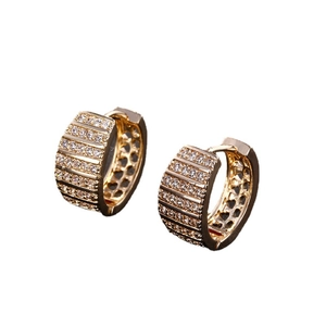 Chunky gold hoop earrings with multi-row sparkling rhinestones on a white background