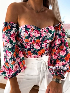 Detail of floral off-shoulder top with lantern sleeves and vibrant flower pattern print