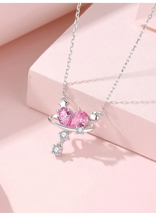 Macro detail of S925 silver necklace with pink heart zircon and star planet pendant