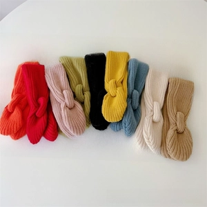 Flat lay of colorful ribbed knit ear warmers for babies in nine vibrant winter colors