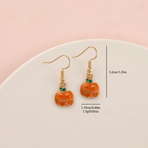 Detail view of orange pumpkin earrings with dimensions 3.2cm height and 1.19cm width