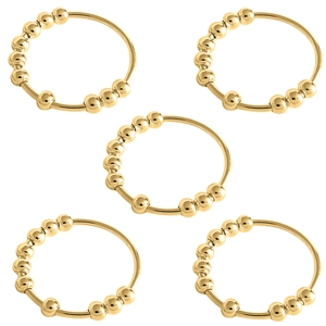 Five gold spinning beads anxiety rings for stress relief on a minimalist metal band