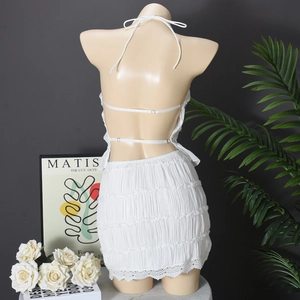 Detailed back view of white halter dress with textured fabric and delicate lace trim