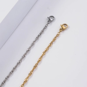 Water wave twist chains in 18K gold and silver stainless steel with lobster clasps