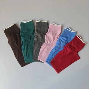 Detailed flat lay of high-waist yoga leggings showing six vibrant colors and ribbed texture