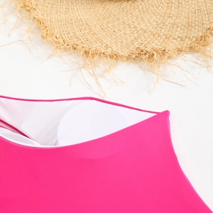 Detail of rose pink swimsuit with white inner lining and circular chest pads for comfort