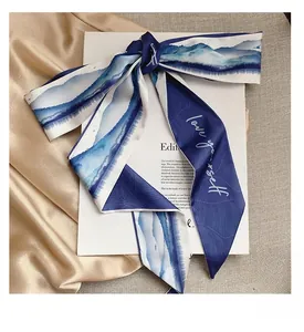 Detailed view of silk twilly scarf with blue gradient art and love yourself text print