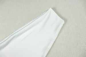 Detail shot of smooth hem stitching on satin halter neck top with silky finish