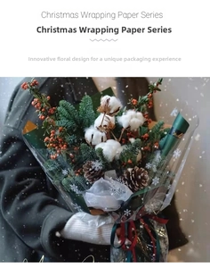 Detail of Christmas wrapping paper with white snowflake patterns on floral bouquet