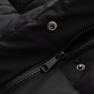 Close-up of premium metal zipper and press stud on a black windproof jacket texture