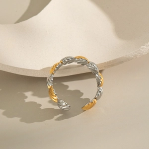 Detail of two-tone gold and silver wave texture adjustable open ring on stone
