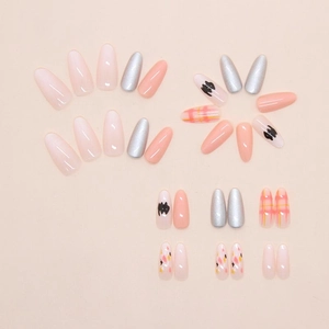 Detailed view of almond press-on nails with cute cat doodles and pink plaid patterns