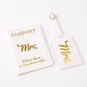 Close-up of white PU leather passport holder and luggage tag set with Mrs. gold foil stamping