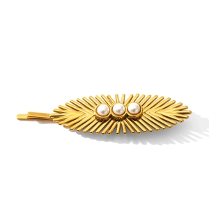 Golden sunburst stainless steel hair clip with three white pearls on white background