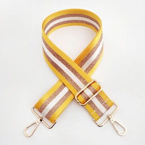 Close-up of a 5cm wide striped bag strap with gold metal hooks in an X-shaped layout