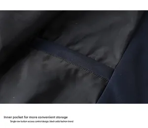 Detail of a dark functional inner pocket on a loose casual men's outdoor jacket