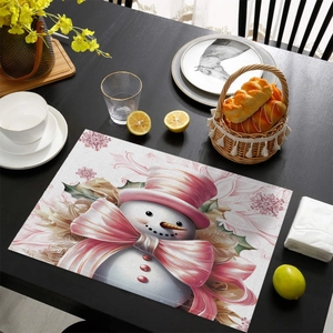 Close-up of pink Christmas snowman placemat showing the woven cotton linen texture