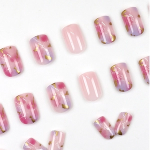 Short square pink press-on nails with marble texture and gold foil accents