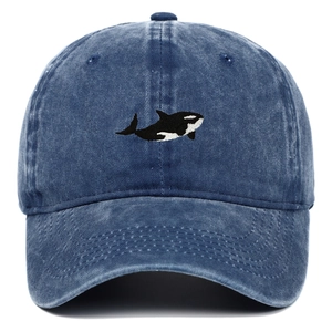 Detailed embroidery of an orca on a vintage washed navy blue denim baseball cap