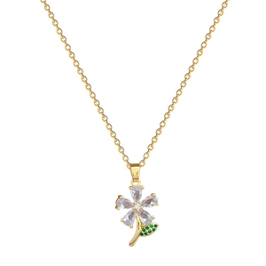 Elegant gold necklace with green leaf flower pendant set with sparkling crystals on white base