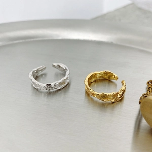 Detailed view of gold and silver irregular textured S925 sterling silver open rings