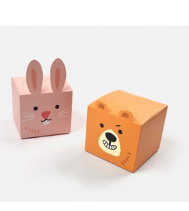 Detail of pink rabbit and orange bear cartoon paper boxes for candies and small gifts