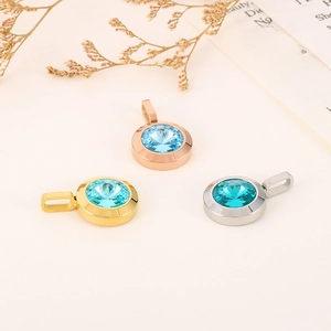 Macro shot of colorful round crystal pendants in gold, rose gold and silver metal frames