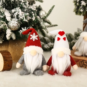 Christmas gnomes set with red snowflake hat and white heart hat in festive winter scene