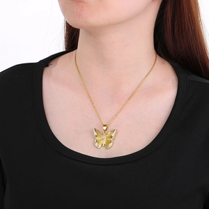 Elegant gold butterfly pendant necklace with crystal rhinestones on a female model