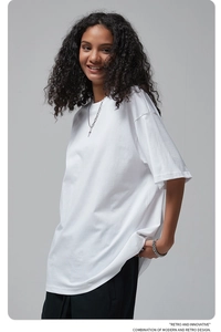 Close-up of oversized white cotton t-shirt featuring retro and innovative graphic text