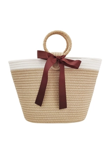 Minimalist beige and white woven cotton rope tote bag with a red ribbon bow detail