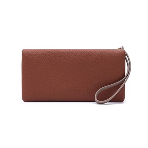 Close-up of brown litchi texture leather long wallet with wristlet and embossed logo
