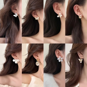 Detailed grid of French vintage floral and butterfly stud earrings with pearls