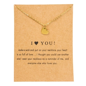 Golden heart pendant necklace on a brown kraft card with a sentimental message