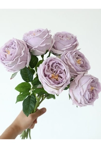 Handheld bouquet of six lavender artificial Austin roses with detailed green leaves