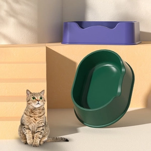 Detail of high-walled semi-enclosed cat litter boxes in matte dark green and purple colors