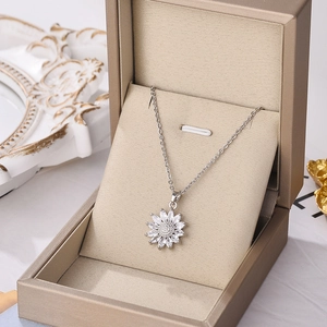 Elegant silver sunflower pendant necklace with zircon crystals in a luxury jewelry box