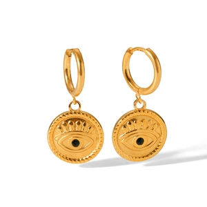 Detail of gold evil eye hoop earrings featuring textured edges and black crystal inlay