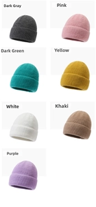 Detail view of ribbed knit beanies in seven various colors including gray, pink, and yellow