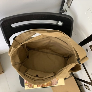 Inside view of khaki canvas tote bag showing large capacity and internal zipper pocket