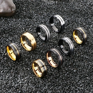 Detailed flat lay of eight matte tungsten steel rings for men on a dark stone background