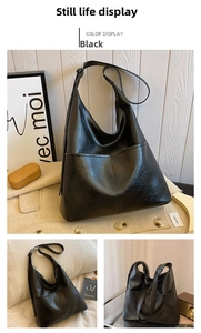 Detail of glossy black leather tote bag with triangle stitching and adjustable wide strap