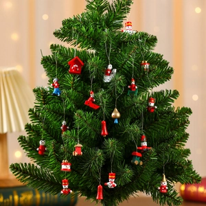 Detailed view of colorful mini wooden Christmas ornaments hanging on a green festive tree