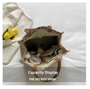 Top view of large woven tote bag interior showing ample storage for tablet and umbrella