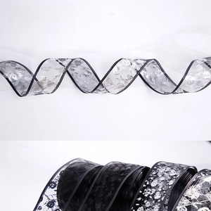 Close-up of translucent Halloween ribbons with pumpkin, skull and spider web patterns