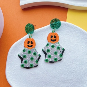 Detail showing Halloween pumpkin ghost acrylic earrings with orange and green glitter finish