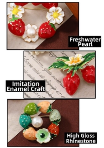 Detail of strawberry brooch featuring freshwater pearls, enamel glaze and rhinestones