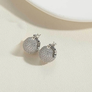 Detail of elegant silver circular hoop earrings with full pave cubic zirconia inlay