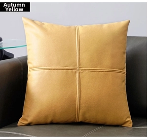 Macro view of autumn yellow technical fabric cushion with cross-stitched texture on sofa